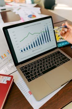 A close-up view of a laptop displaying business analytics and revenue charts.